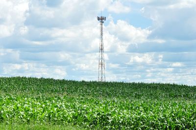 Electricity pylon on field against sky
