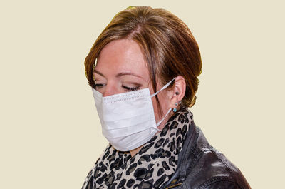 Woman wearing mask against white background