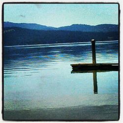 Calm lake with mountains in background