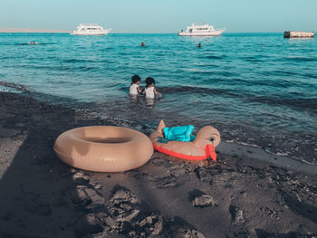 Toy on beach against sky