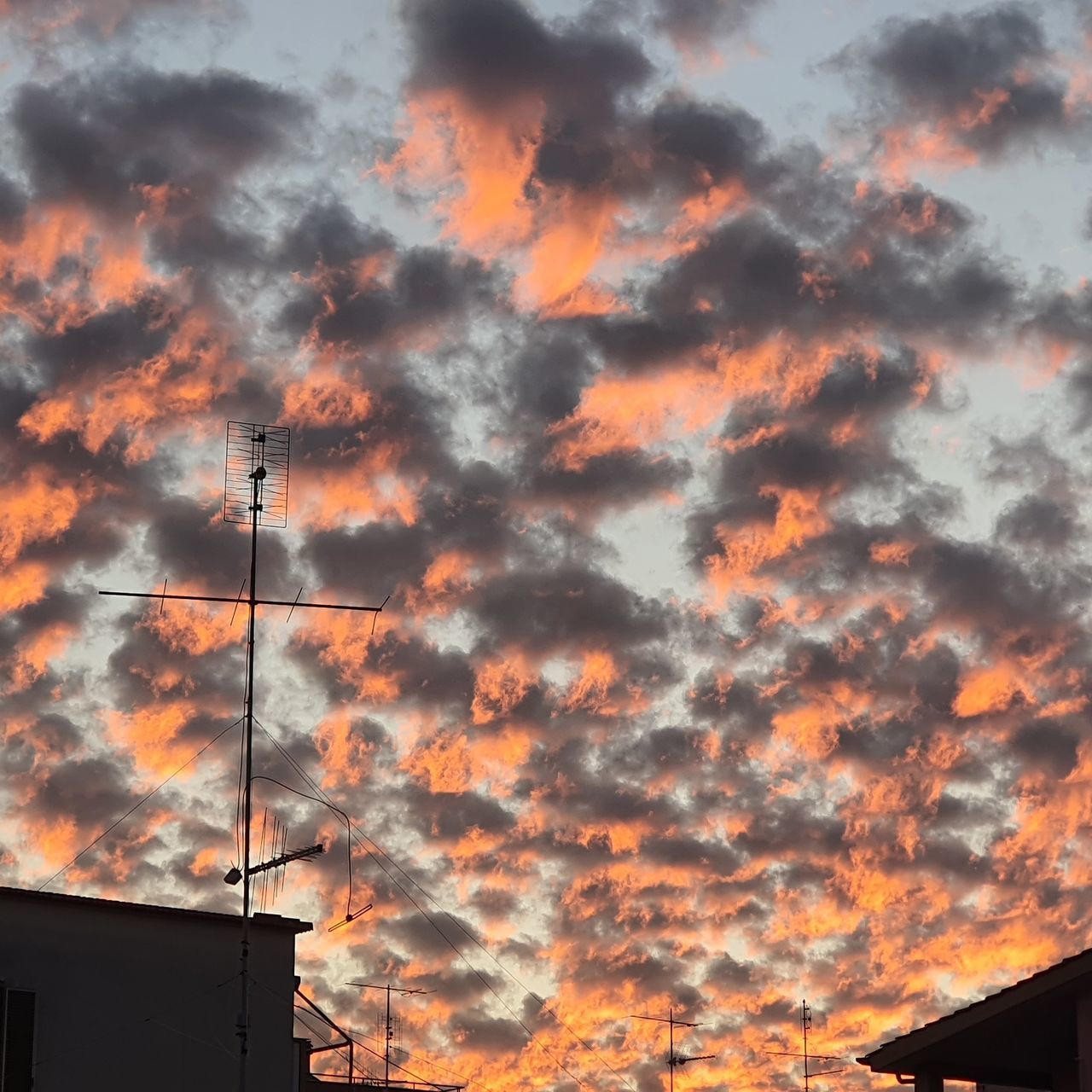 LOW ANGLE VIEW OF SILHOUETTE BUILDING AGAINST ORANGE SKY