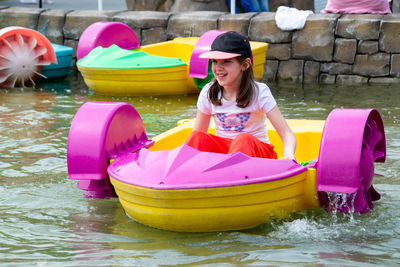 Kid playing rowing water paddle boat. soft focus. . high quality photo