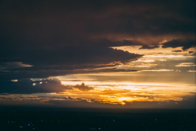 Scenic view of sea against dramatic sky during sunset