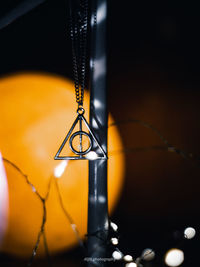 Close-up of illuminated lighting equipment hanging at night