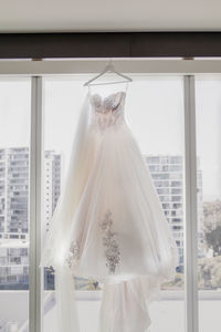 White wedding dress gown by the window