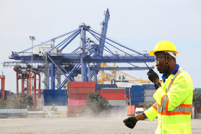 Low angle view of man working at construction site