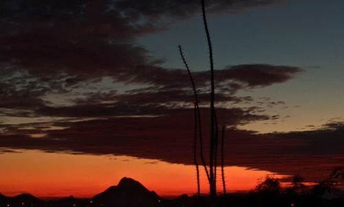 Low angle view of silhouette mountain against dramatic sky