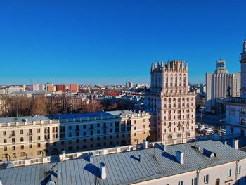 High angle view of buildings against clear blue sky