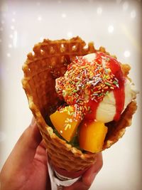 Close-up of hand holding ice cream