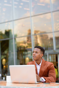 Businessman looking away while sitting at cafe