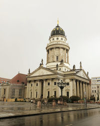 Buildings in city against clear sky