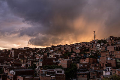 Buildings in city against sky during sunset