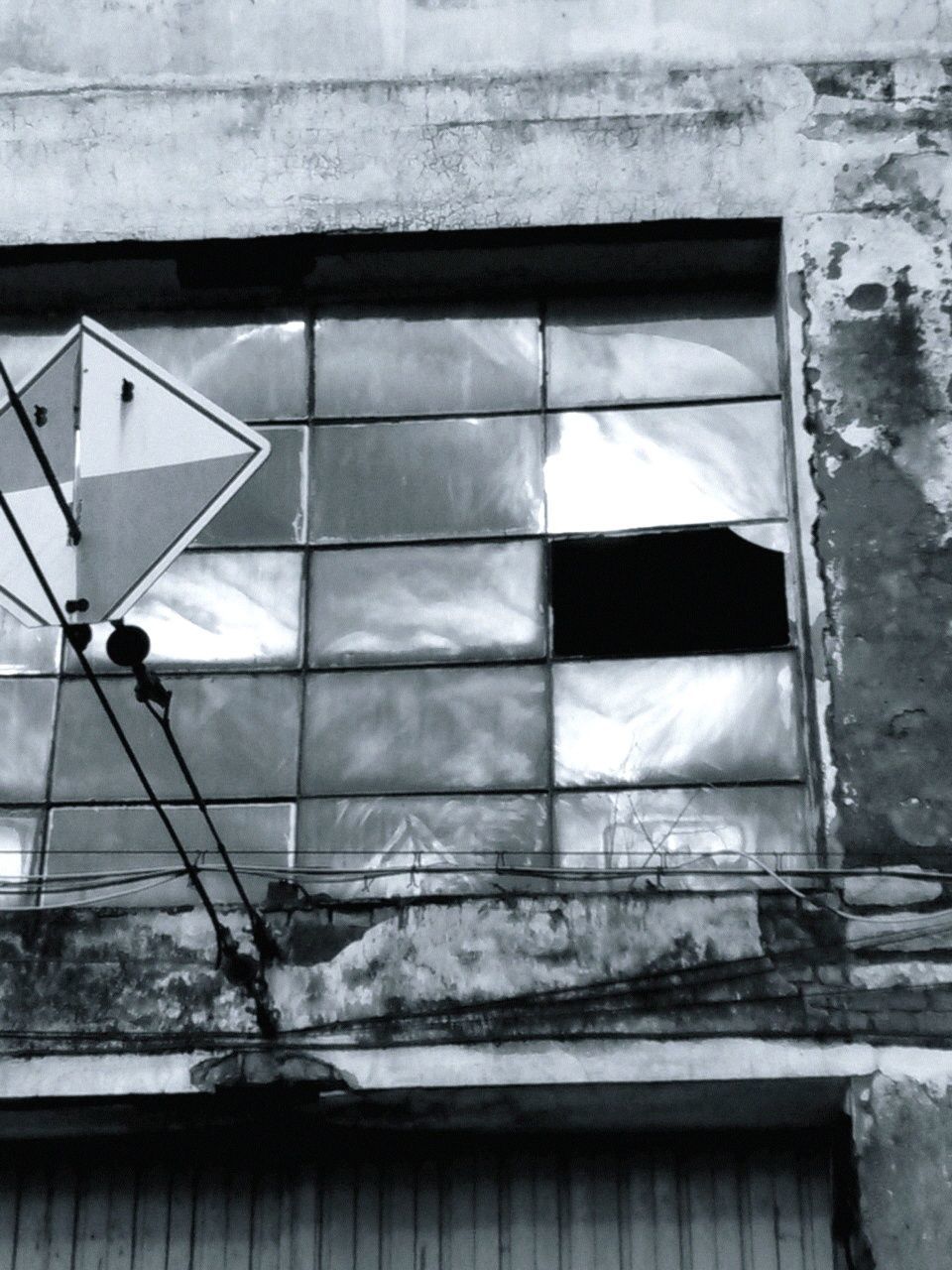 architecture, built structure, building exterior, window, low angle view, building, brick wall, old, wall - building feature, abandoned, damaged, day, weathered, glass - material, outdoors, wall, house, no people, reflection, residential structure