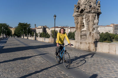 Man riding bicycle in city