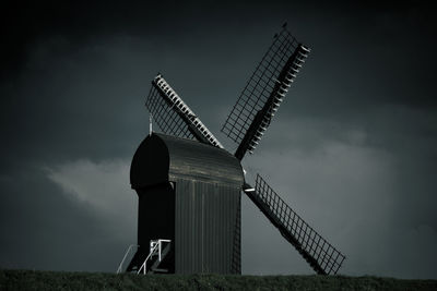 Low angle view of traditional windmill against sky