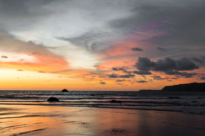 Scenic view of beach against sky during sunset