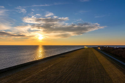 View of sea against cloudy sky during sunset