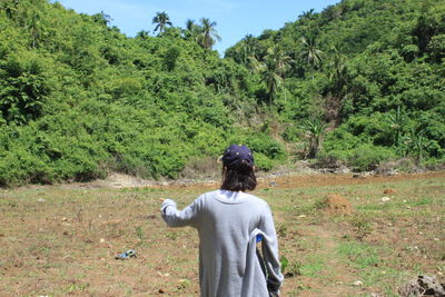 Rear view of man looking at field