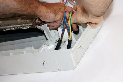 Midsection of man working on table