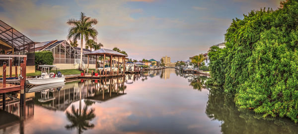 Sunrise over a waterway leading to the ocean near vanderbilt beach in naples, florida.