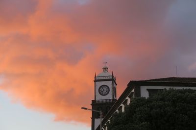 Low angle view of clock tower against sky during sunset