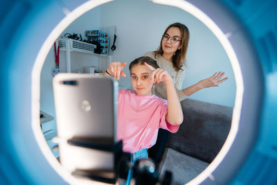 Mother and daughter record video use smartphone