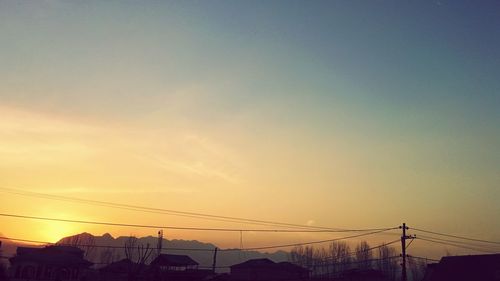 Low angle view of electricity pylon against sky