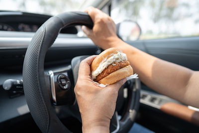 Cropped hand of person holding food