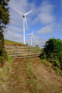 Windmill on field against sky