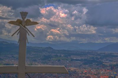 Aerial view of city and mountains against sky