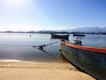 Boats moored on sea against clear sky