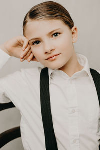 Portrait of girl wearing suspenders and shirt