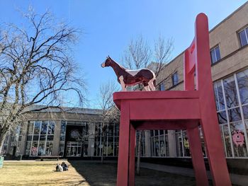 Man with dog against built structure