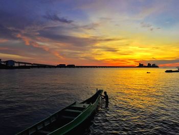 Scenic view of river against sky during sunset