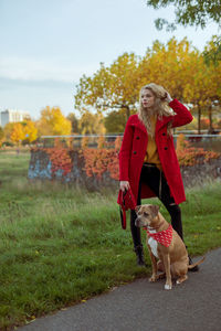 Full length of woman with dog