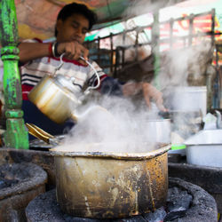 Man preparing tea at stall