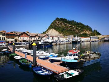 Boats moored at harbor