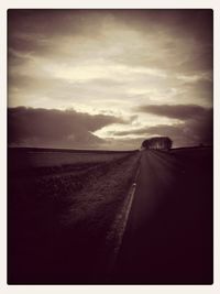 Scenic view of road against cloudy sky