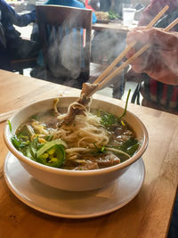 Midsection of soup in bowl on table