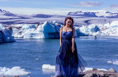 Young woman standing on snow covered mountain