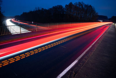 High angle view of light trails on road at night