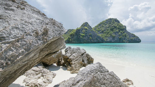 Scenic view of sea and mountains against sky