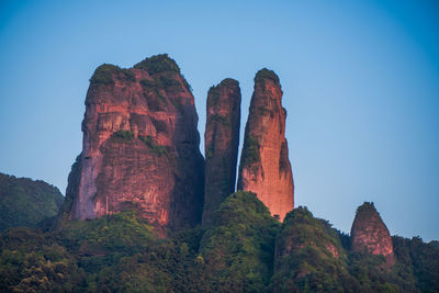 Low angle view of rock formations against blue sky