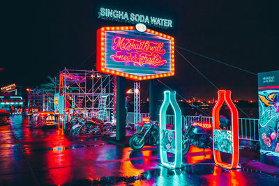 Illuminated amusement park ride at night