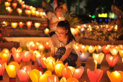 Woman with illuminated candles