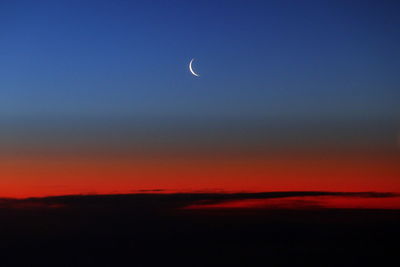 Scenic view of moon in sky at sunset