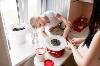 High angle view of mother preparing food at home