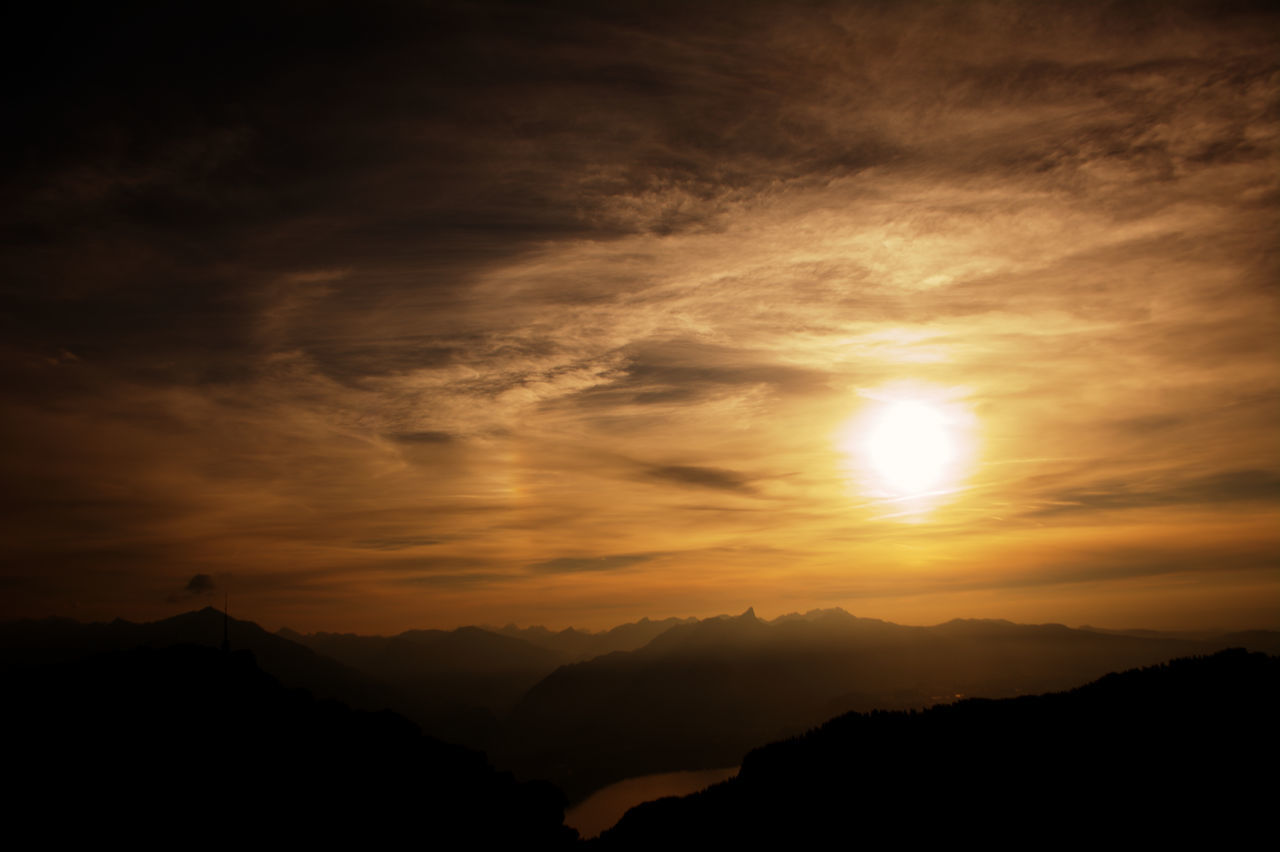 SILHOUETTE MOUNTAINS AGAINST SKY AT SUNSET