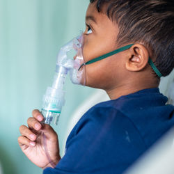 Close-up portrait of boy drinking water