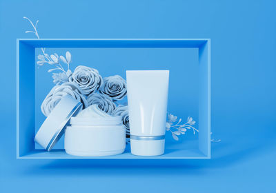 Close-up of white flower on table against blue background